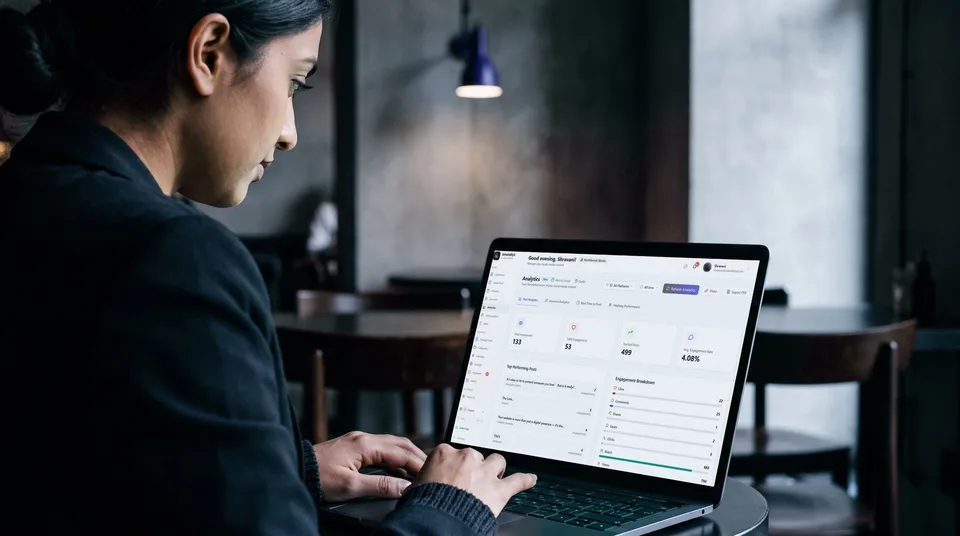 A marketer reviewing Instagram analytics on a laptop in a stylish cafe.