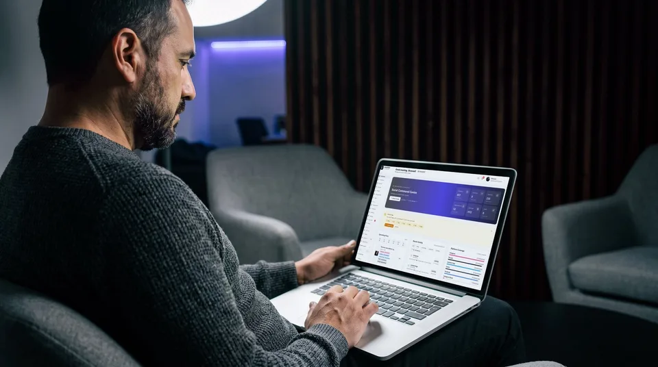 A marketing manager reviews a social media scheduling dashboard on a laptop in a modern office lounge.