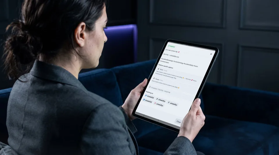 A strategist reviewing AI-tailored captions for TikTok and Threads on a tablet.