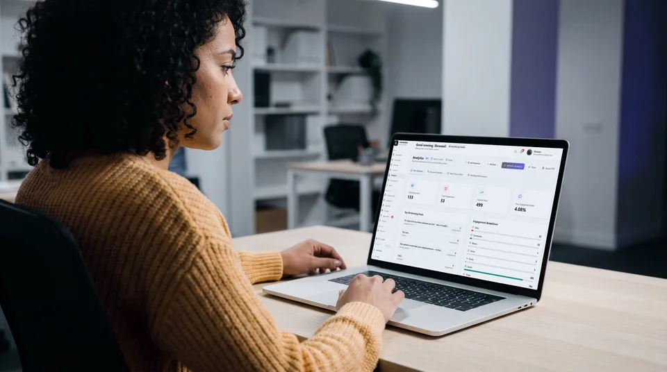 A woman reviews SchedulifyX analytics on her laptop in a modern office.