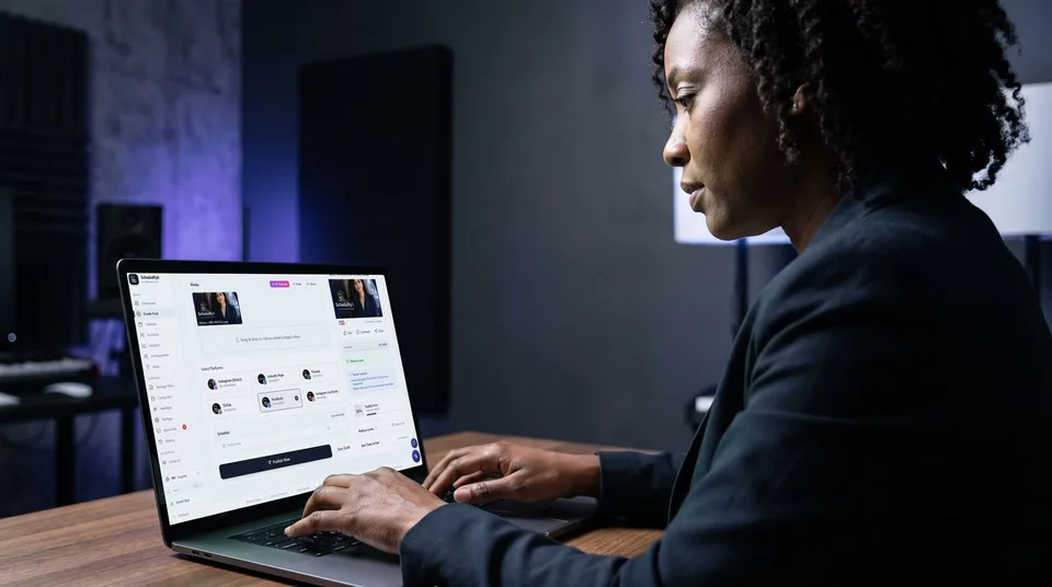 A woman typing on a laptop in a modern studio, using the SchedulifyX composer.