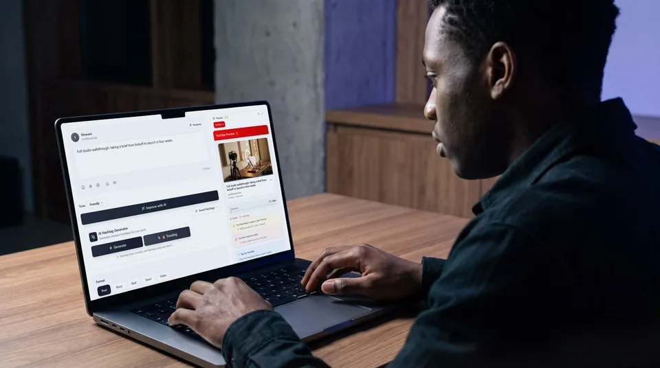 A man at a desk looking at a YouTube video preview on his laptop.